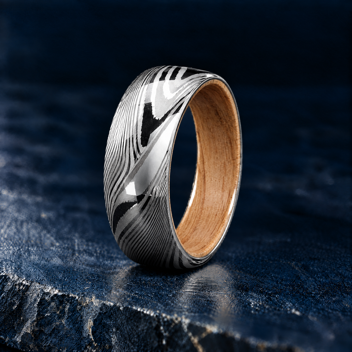 The Grove Damascus steel ring with oak wood lining, angled view