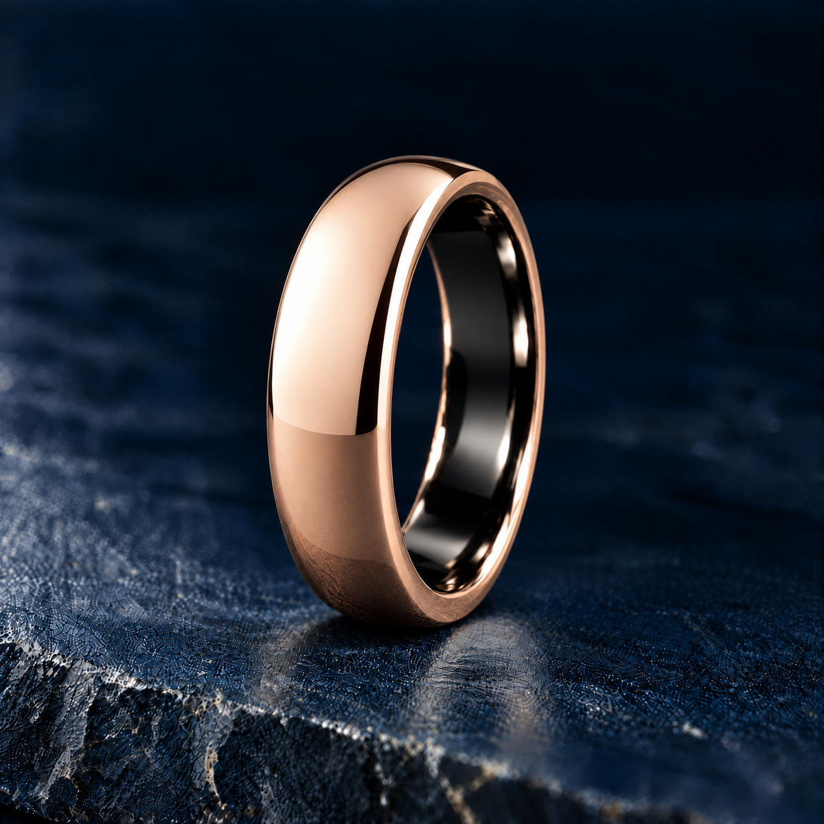 The Sovereign polished rose gold tungsten ring, domed court profile, angled view