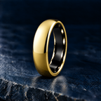 The Sovereign polished gold tungsten ring, domed court profile, angled view